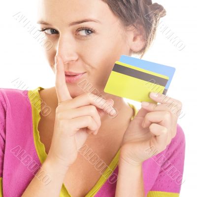 Beautiful young woman looks down at colorful credit cards in her