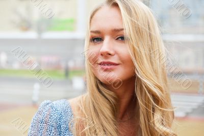 Closeup portrait of a beautiful woman in the city at summer time