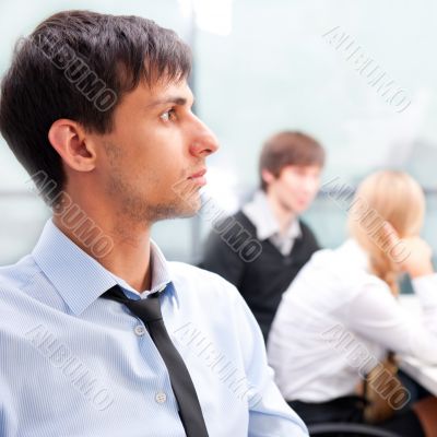 Closeup portrait of a smart young businessman smiling and his co