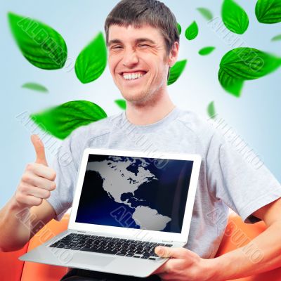 Portrait of young man sitting indoors at his office and working.