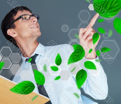 Portrait of young man sitting indoors at his office and working.