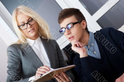 Young and good-looking business people are working in the office