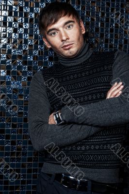 Fashion portrait of the young beautiful man inside luxury glamor