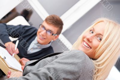 Young successful smiling business people are working in the offi