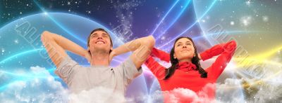 Smiling beautiful couple sitting on a sofa at their apartment an