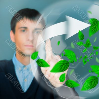 Portrait of young man sitting indoors at his office and working.