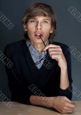 Closeup portrait of a cheerful young business man sitting at his