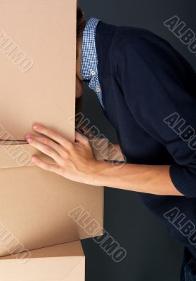 Portrait of anonymous young man with his head inside box