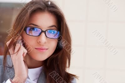 Beautiful business woman on the phone at modern building. Outdoo