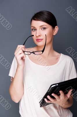 Portrait of young pretty woman holding tablet computer and glass
