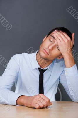 Closeup of a young business man having a stress. Headache. Again