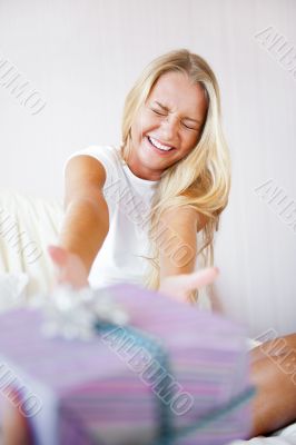 Boyfriend making a gift to his girlfriend in the morning. She is