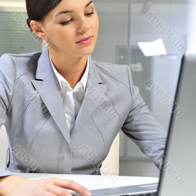 Young business woman on a laptop at her office. Working