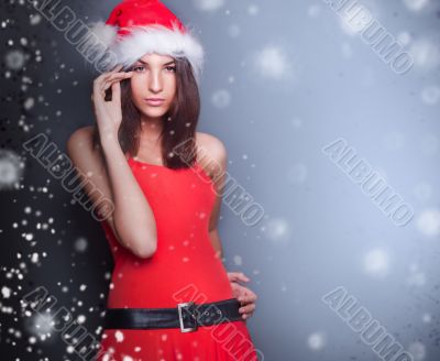 Portrait of beautiful young christmas woman posing wearing santa