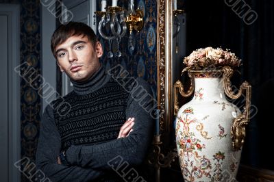 Elegant man posing in a stylish interior