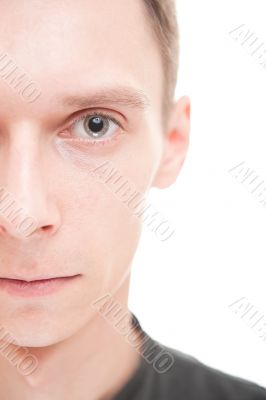Closeup portrait of serious young man looking at camera