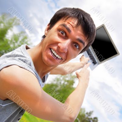 casual young man pointing at laptop screen