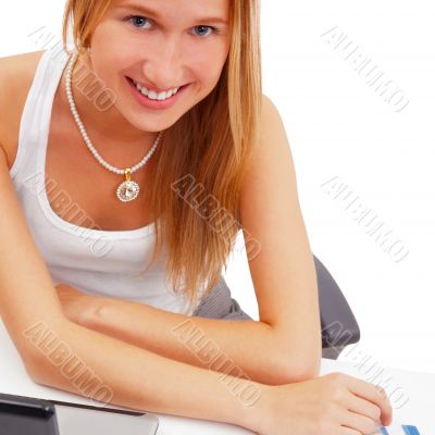 Portrait of a pretty female student with laptop and exercise boo