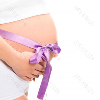 Image of pregnant woman touching her belly with hands