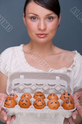 Portrait of young pretty business woman against grey background 