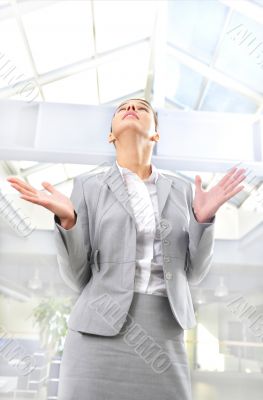 A portrait of a young business woman in an office with documents