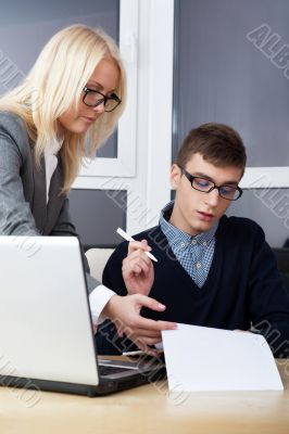 Young and good-looking business people are working in the office