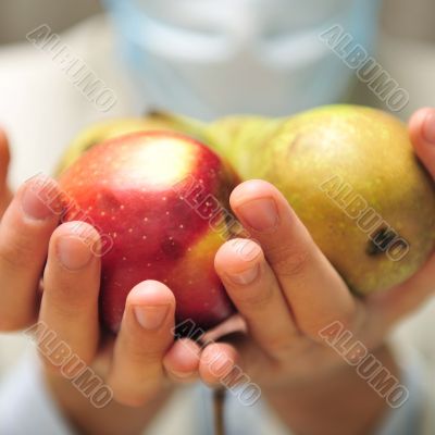 Doctor holding fresh fruits in his arms