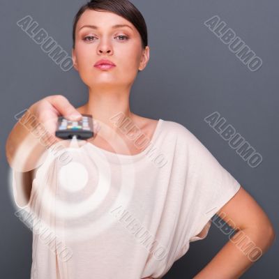 Portrait of a beautiful fashionable elegant woman with remote co