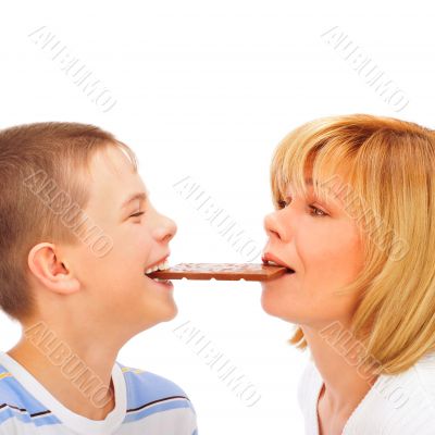 Portrait of happy european family of son and his mother eating c