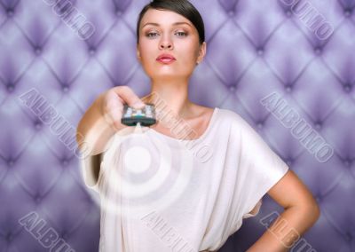 Portrait of a beautiful fashionable elegant woman with remote co