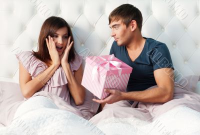 Closeup portrait of a happy young couple relaxing on the bed. Ma