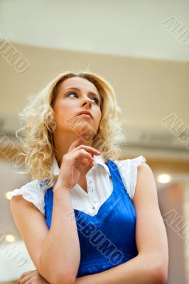 A portrait of a young business woman in a hall of an office buil