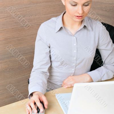 Portrait of a beautiful young businesswoman on the compuer, look