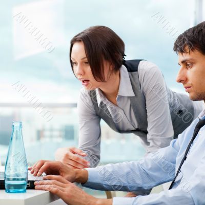 A business team of two colleagues planning work in office