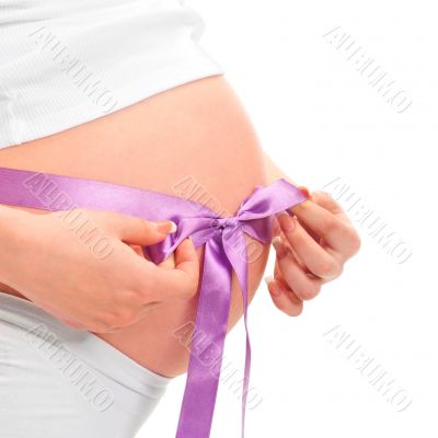 Image of pregnant woman touching her belly with hands