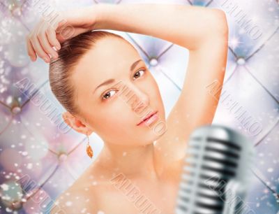 Portrait of a glamorous girl at stage singing and dancing Portrait of a glamorous girl at stage singing and dancing