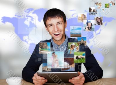 Portrait of young happy man sharing his photo and video files in