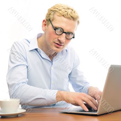 Portrait of funny man screaming during typing a document on his 