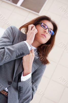 Beautiful business woman on the phone at modern building. Outdoo Beautiful business woman on the phone at modern building. Outdoo