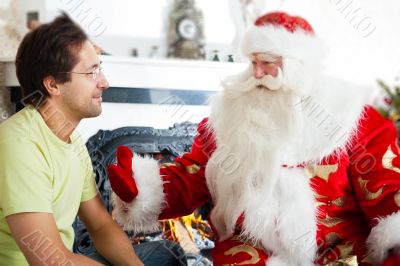 Two adult men - old father wearing Santa Claus suit and his adul