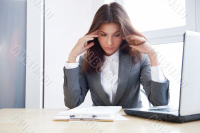 Tired business woman working on her workspace Tired business woman working on her workspace