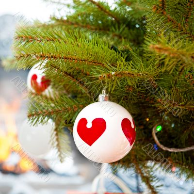 Christmas baubles against burning flame in fireplace on christma