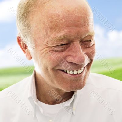 Portrait of a happy senior man smiling over bright background