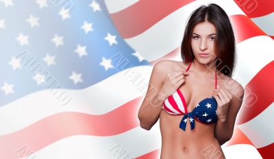 20-25 years old beautiful woman in swimsuit with american flag a