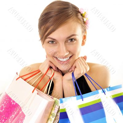 Portrait of lovely woman with shopping bags over white