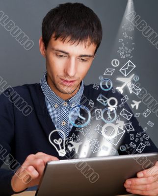 Closeup of a young smiling business man sitting at his office ag