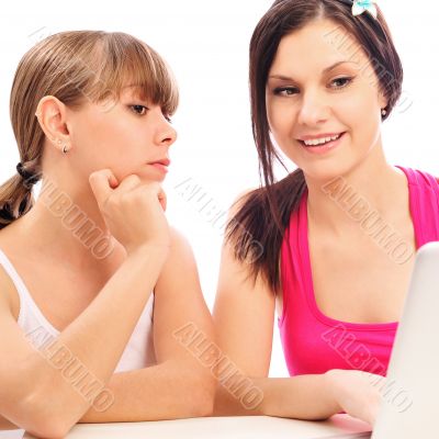 Two teen-girls with laptop. Isolated on white background. They a