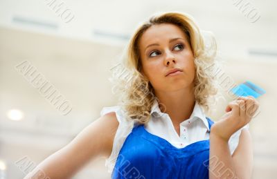 Beautiful shopping woman holding a credit card