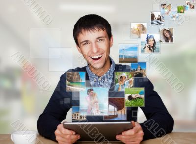 Portrait of young happy man sharing his photo and video files in