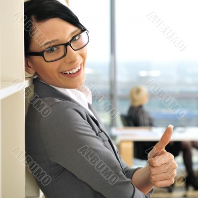 Closeup portrait of pretty cheerful business woman in an office 